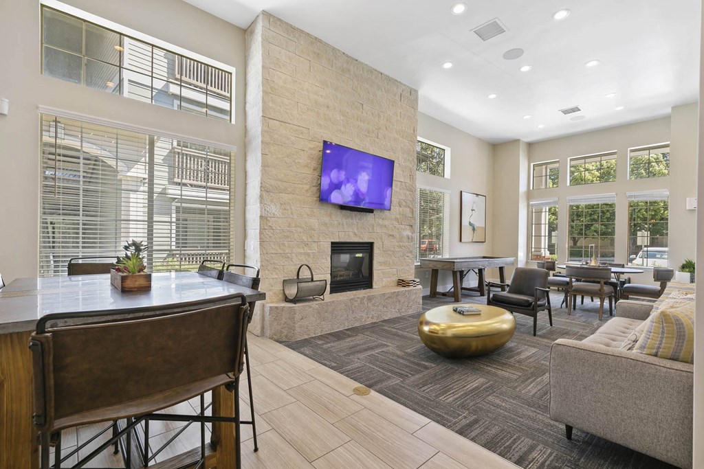 a living room with a fireplace and a table with chairs at Ascent Apartments, Cottonwood Heights, 84121