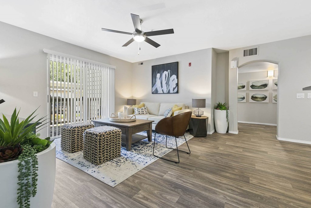 a living room with furniture and a ceiling fan at Ascent Apartments, Cottonwood Heights Utah