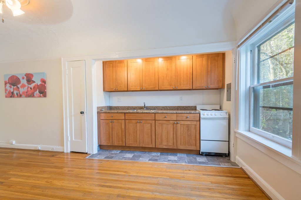 A kitchen with wooden cabinets and a white dishwasher. A kitchen with wooden cabinets and a white dishwasher.at Palladian Apartments, Oregon, 97201?