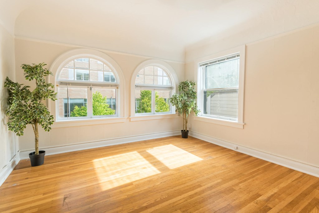 A room with wooden floors and two potted plants. A room with wooden floors and two potted plants.at Palladian Apartments, Portland, OR 97201 ?