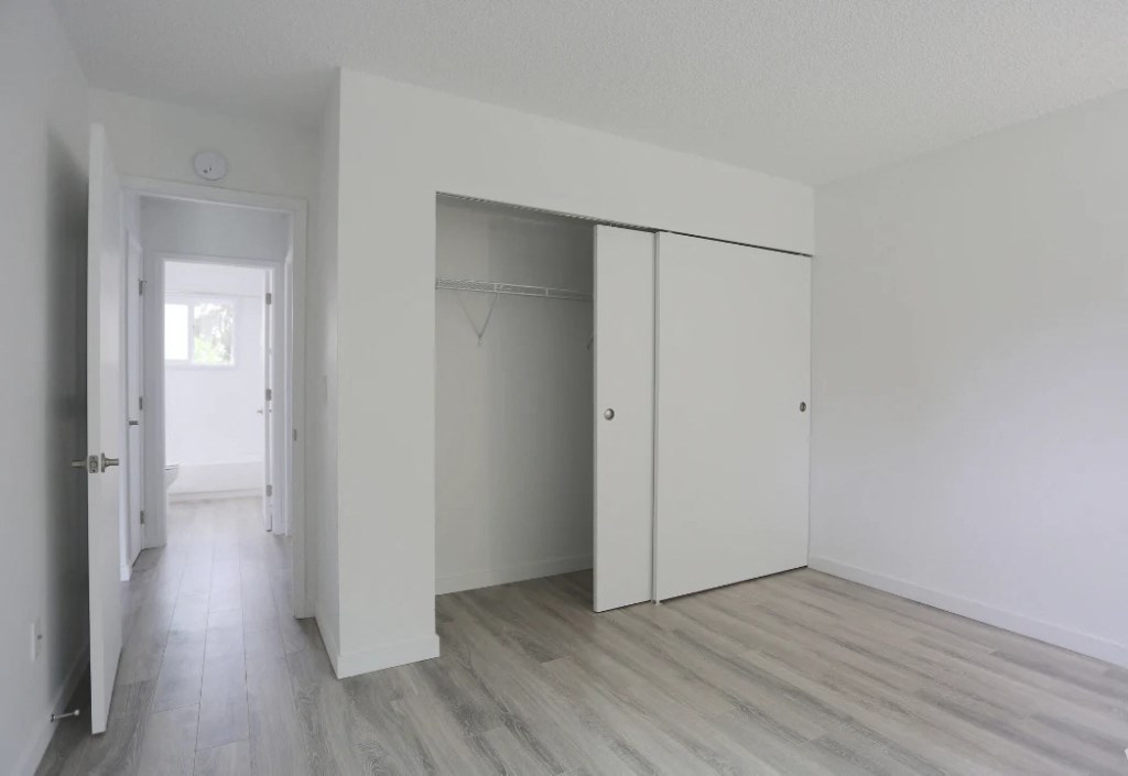 A room with a white door and a white closet.at Tigardville Apartments, Tigard, OR