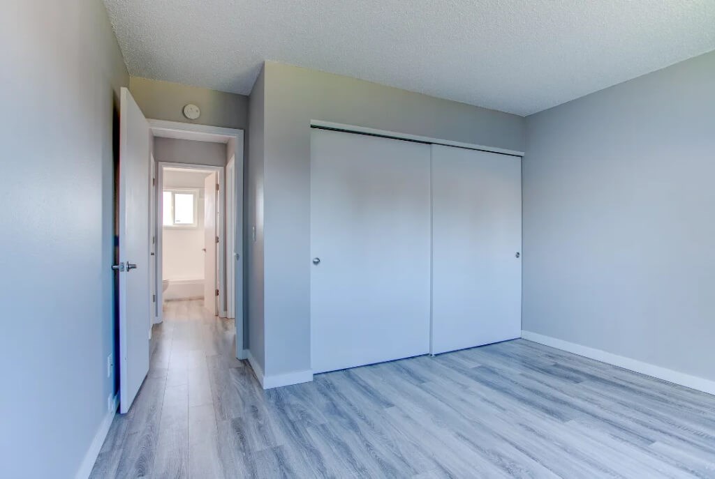 A hallway with a white door and a white closet.at Tigardville Apartments, Tigard, OR
