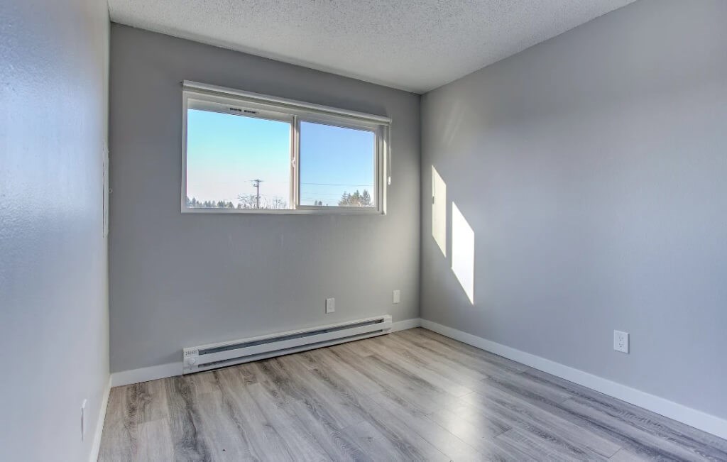 A room with a window and a wooden floor.at Tigardville Apartments, Tigard, OR 97223