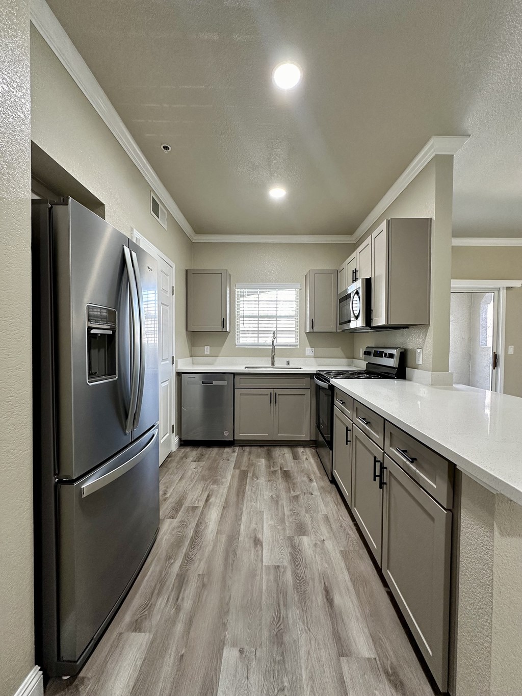 a kitchen with stainless steel appliances and a white counter top