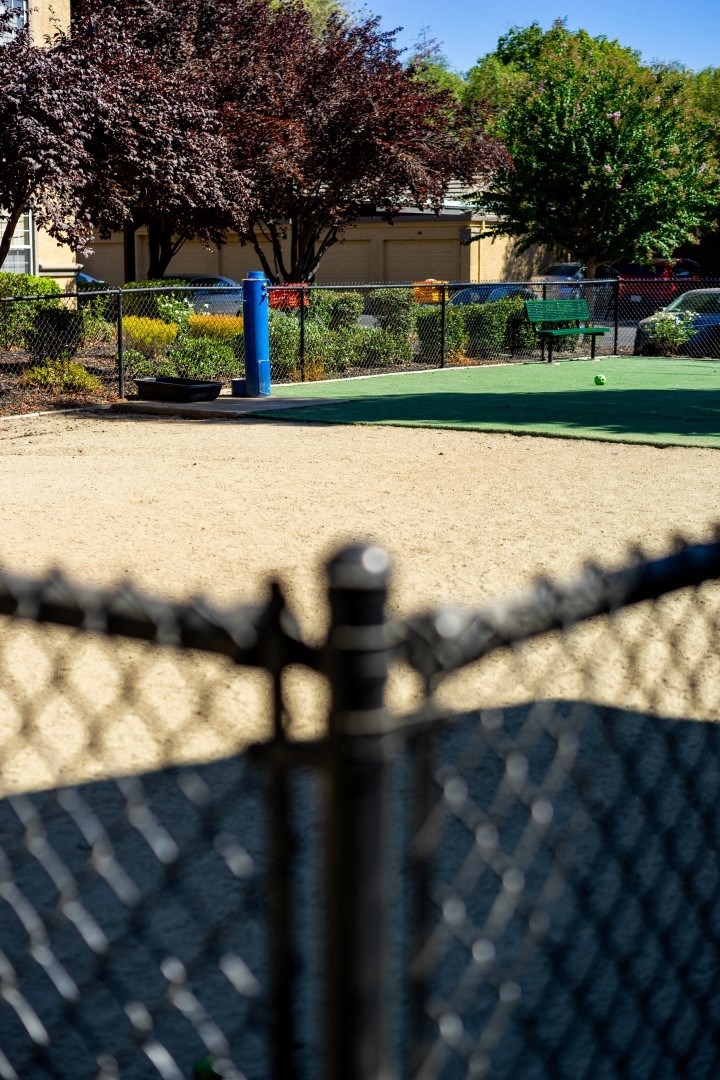 a tennis court with a fence in front of it