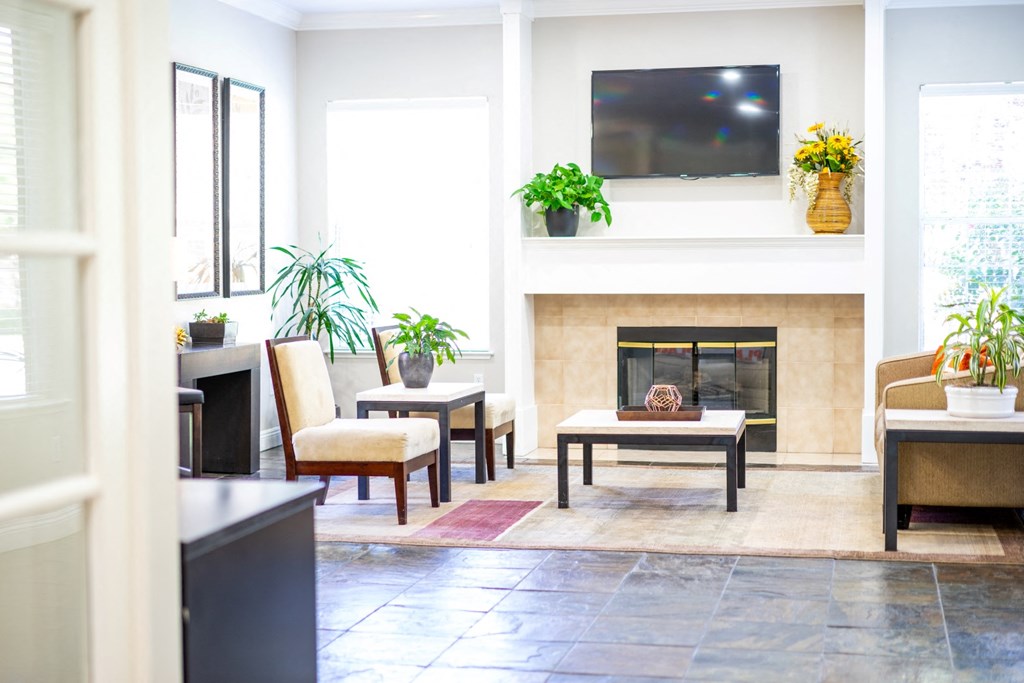 a living room with a fireplace and a flat screen tv