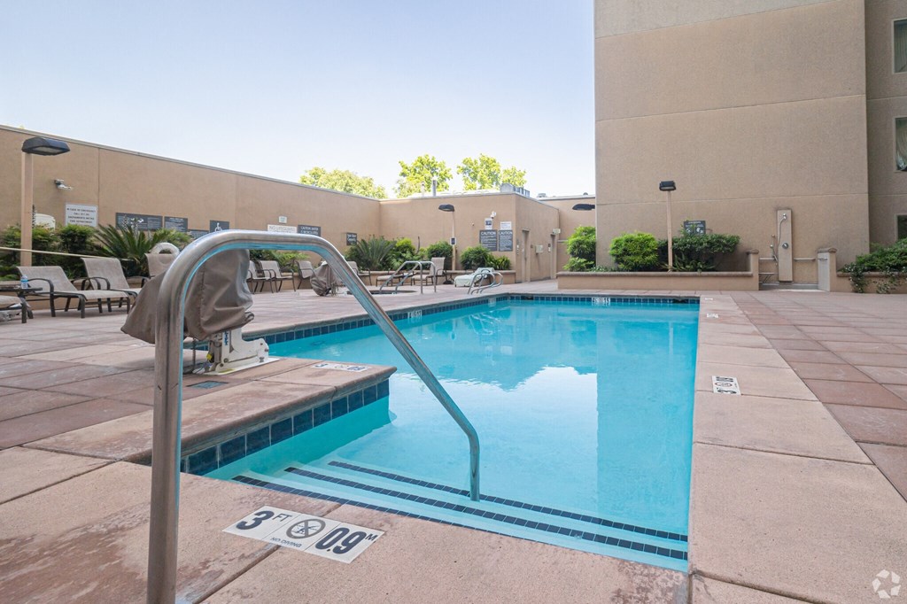 Midtown Sacramento, CA Apartments For Rent - Sparkling Pool With Lounge Chairs, Tables, And Maintained Landscaping