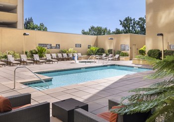 a resort style pool with lounge chairs and a hot tub - Photo Gallery 7