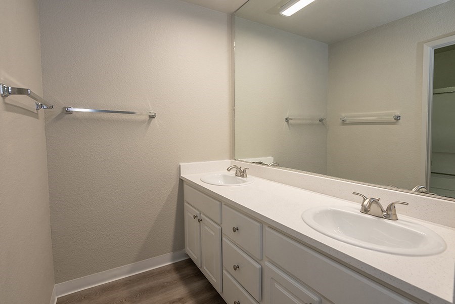 a bathroom with two sinks and a mirror