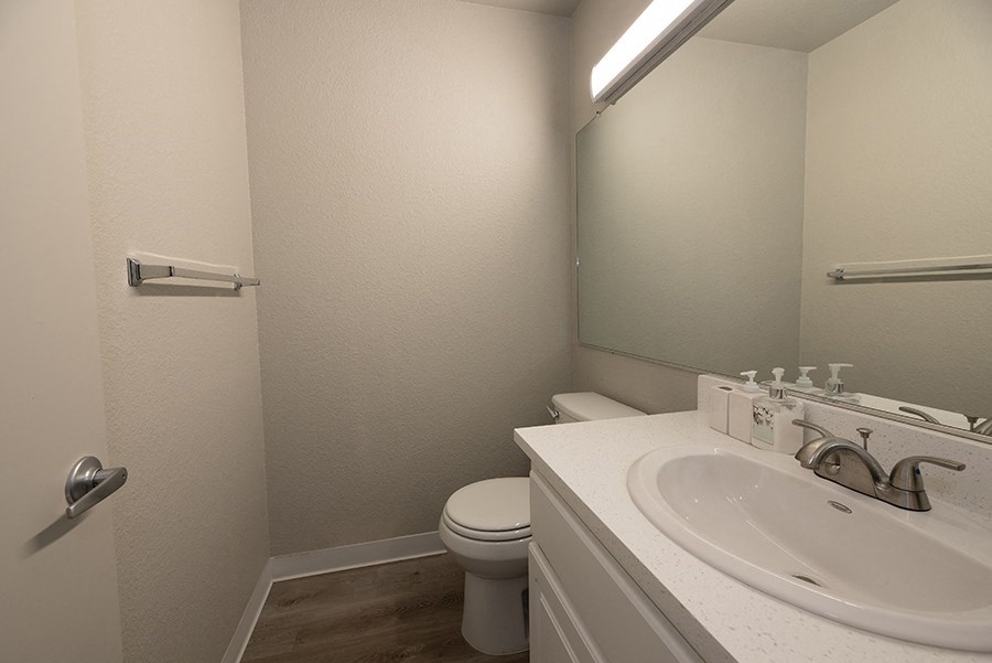 a bathroom with a sink toilet and mirror