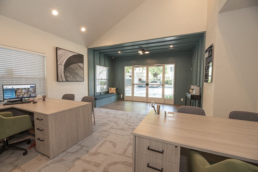 a room with two desks and a computer