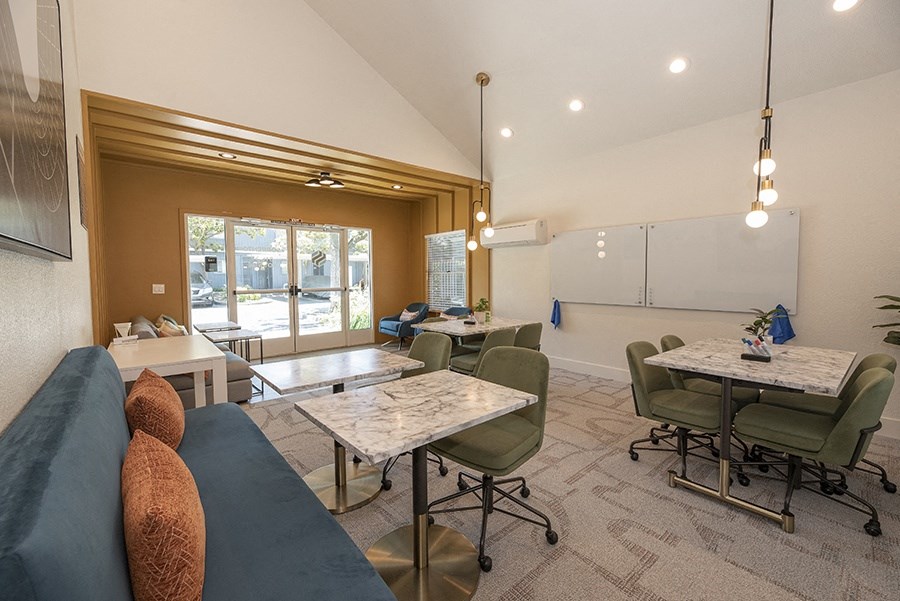 a room with a couch tables and chairs