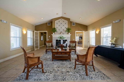 A living room with a fireplace and chairs.