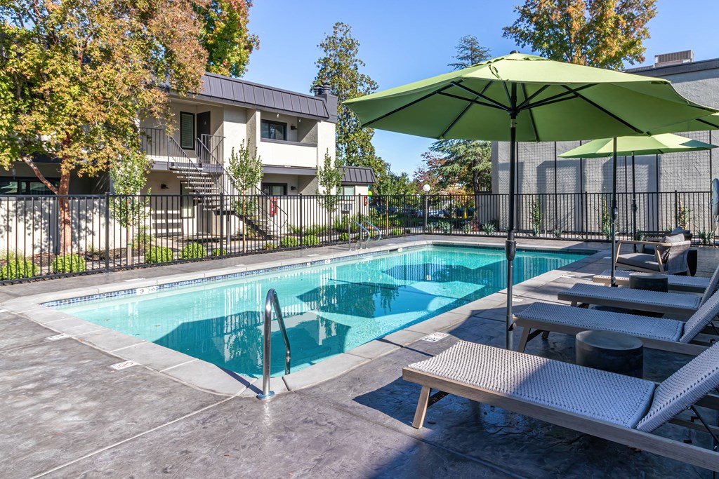 3 BR Apartments in Carmichael CA - Terra Vida - Pool with Lounge Chairs and Umbrellas.