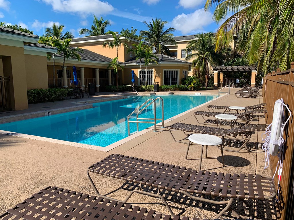 Portofino Apartments resort style pool and lounge chairs with palm trees