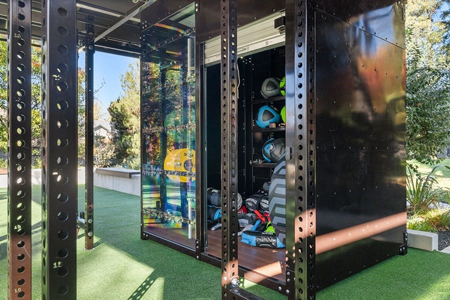 a set of glass doors on a playground with artificial grass