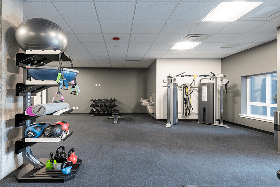 a large fitness room with weights and other exercise equipment