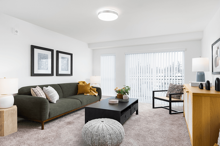 a living room with white walls and carpet