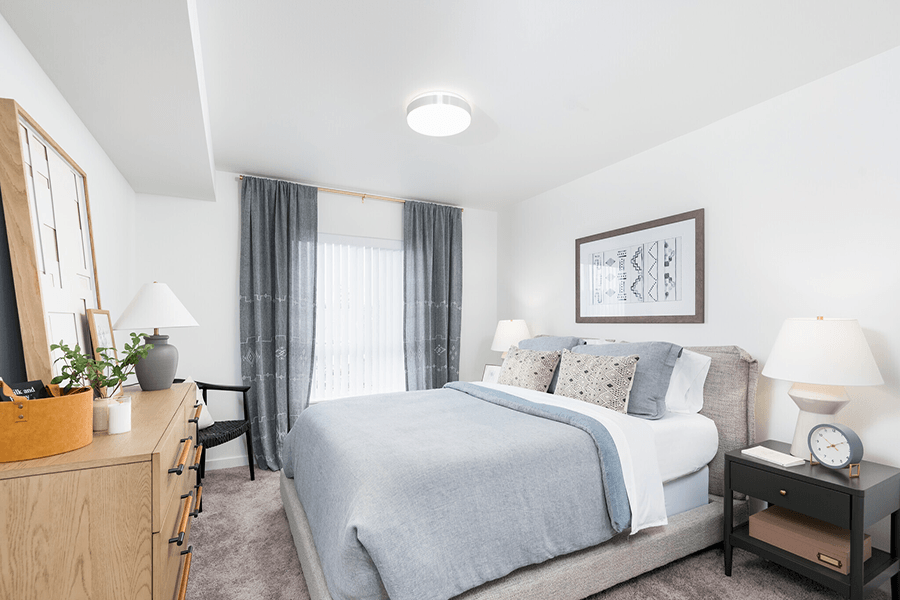 a bedroom with a bed and a dresser