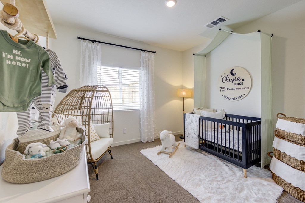 a nursery with a crib and a rocking chair
