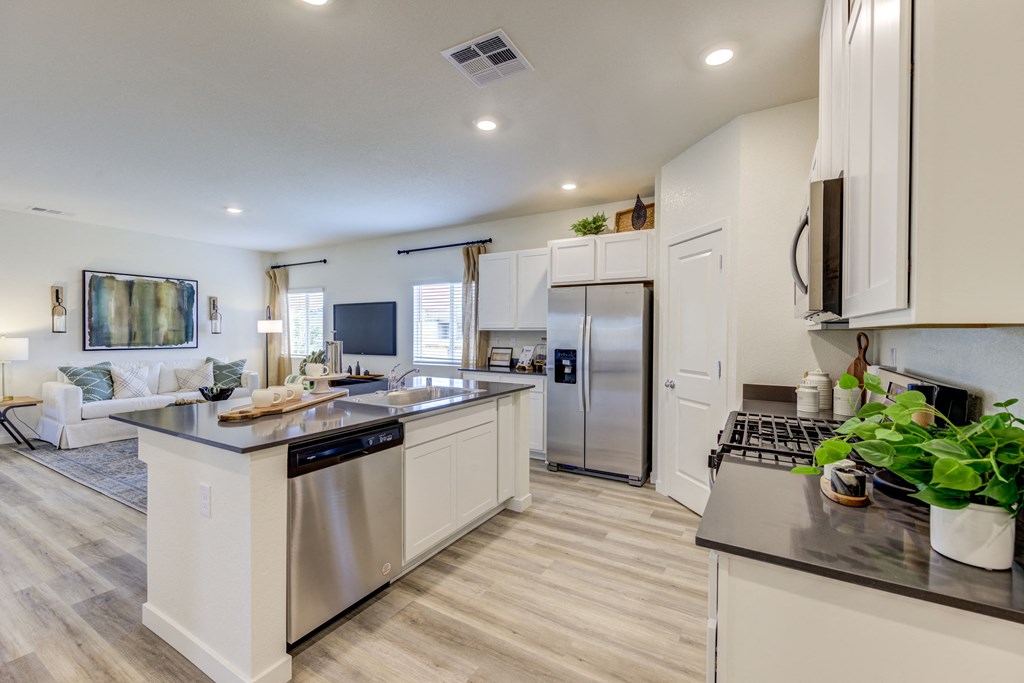 Fernley, NV Houses For Rent - The Pines at Ponderosa - Gourmet Kitchen With Quartz Countertops, Modern Cabinetry, Stainless Steel Appliances, Kitchen Island, Dishwasher, pantry, And Luxury Vinyl Plank