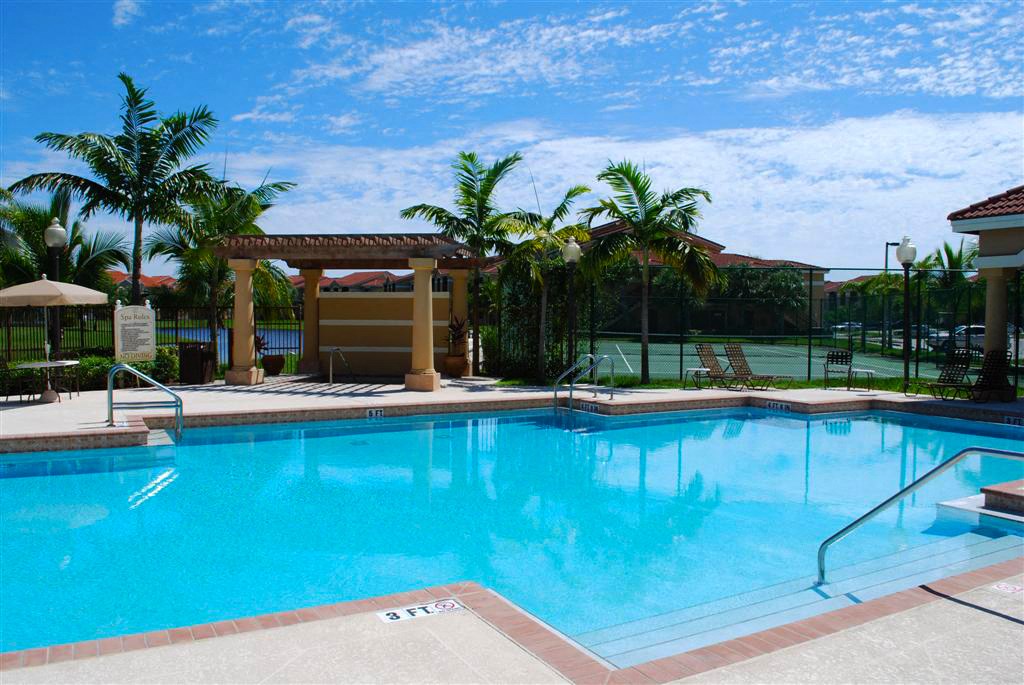 Renaissance resort style swimming pool with chairs and umbrellas