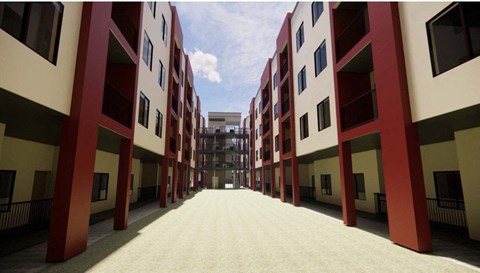 A long corridor with red and white buildings on either side at Vintage at Lockwood Apartments, Oxnard