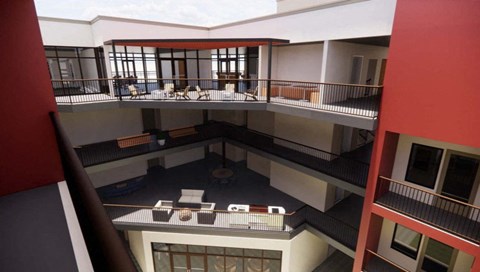 A balcony with chairs and a table is visible from an upper floor at Vintage at Lockwood Apartments, Oxnard 93036