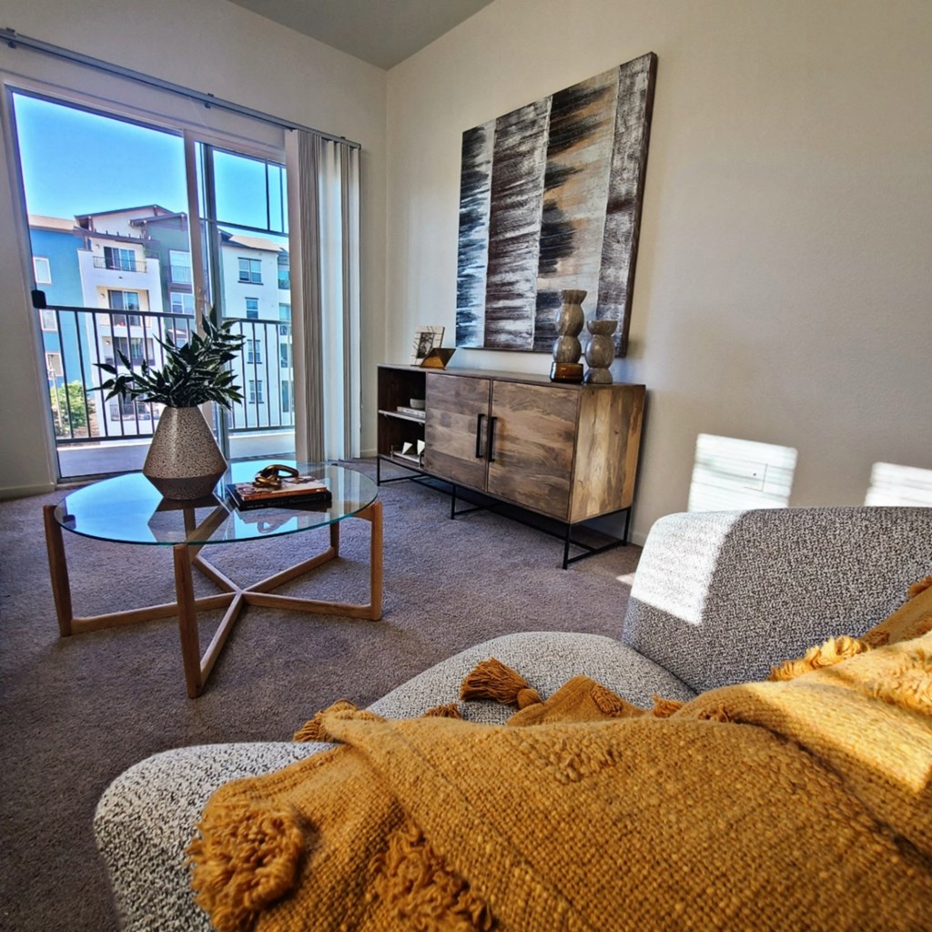 a living room with a couch and a chair and a window