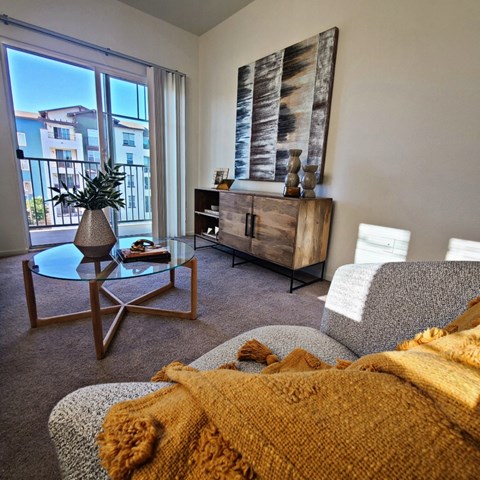 a living room with a couch and a chair and a window