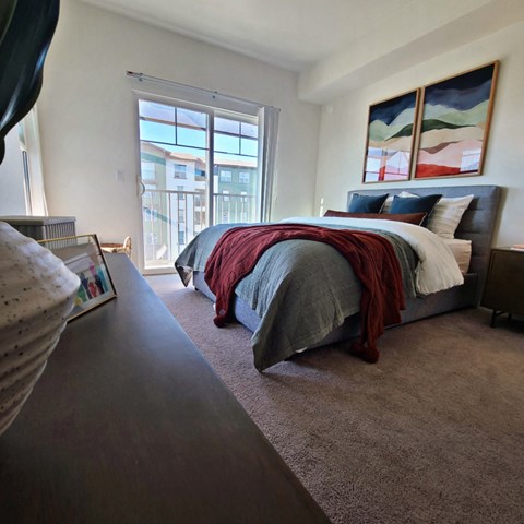 a bedroom with a bed and a large window