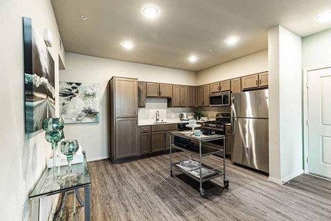 a kitchen with stainless steel appliances and wooden cabinets