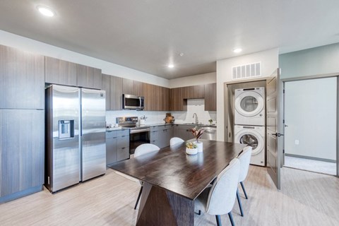 a kitchen with stainless steel appliances and a dining table