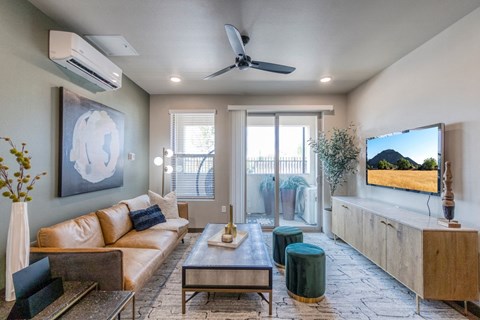 a living room with a couch and a ceiling fan