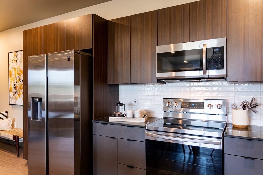 Double R kitchen with stainless steel refrigerator, stove and microwave