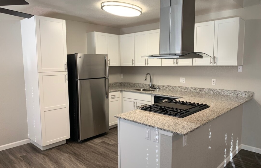 Kitchen with appliance and white cabinets