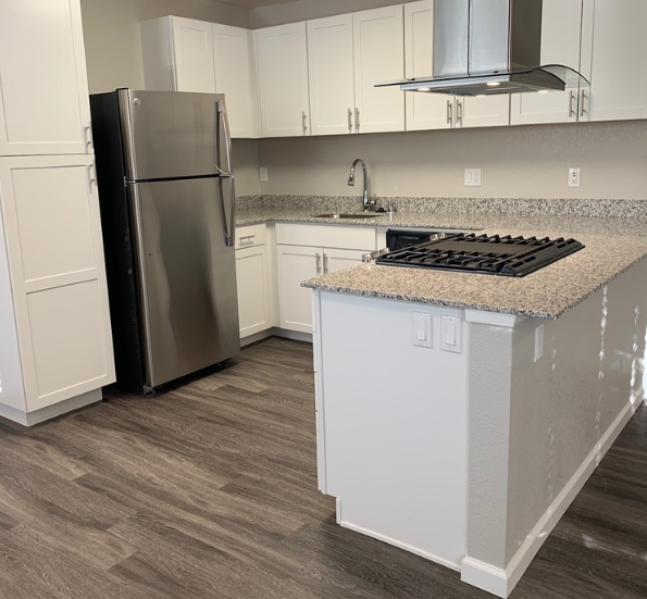 Kitchen with appliance and white cabinets