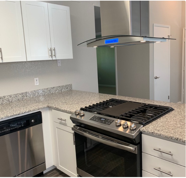 Kitchen with appliance and white cabinets