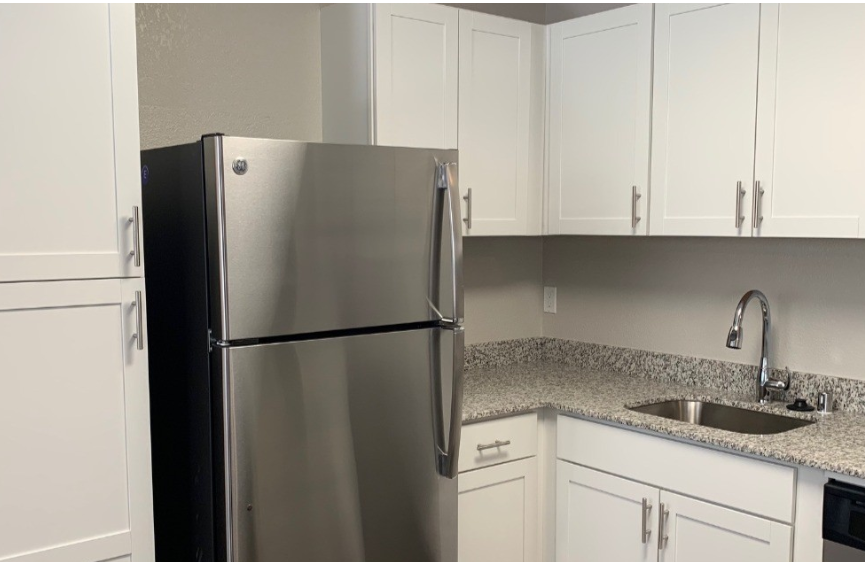 Kitchen with appliance and white cabinets