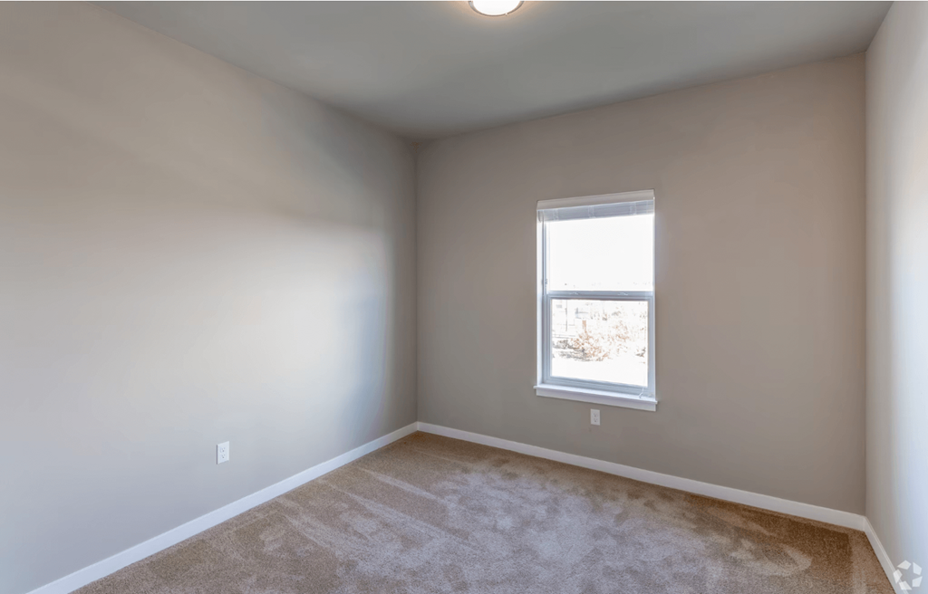 bedroom with window and carpeting