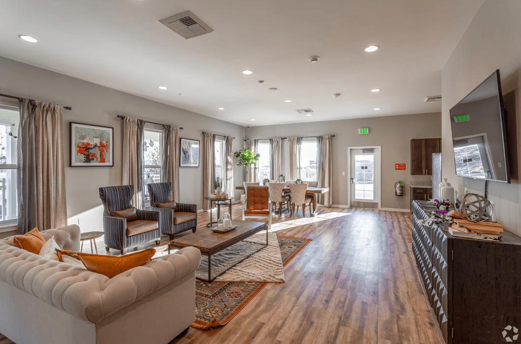 clubhouse with table, chairs, couches, and television