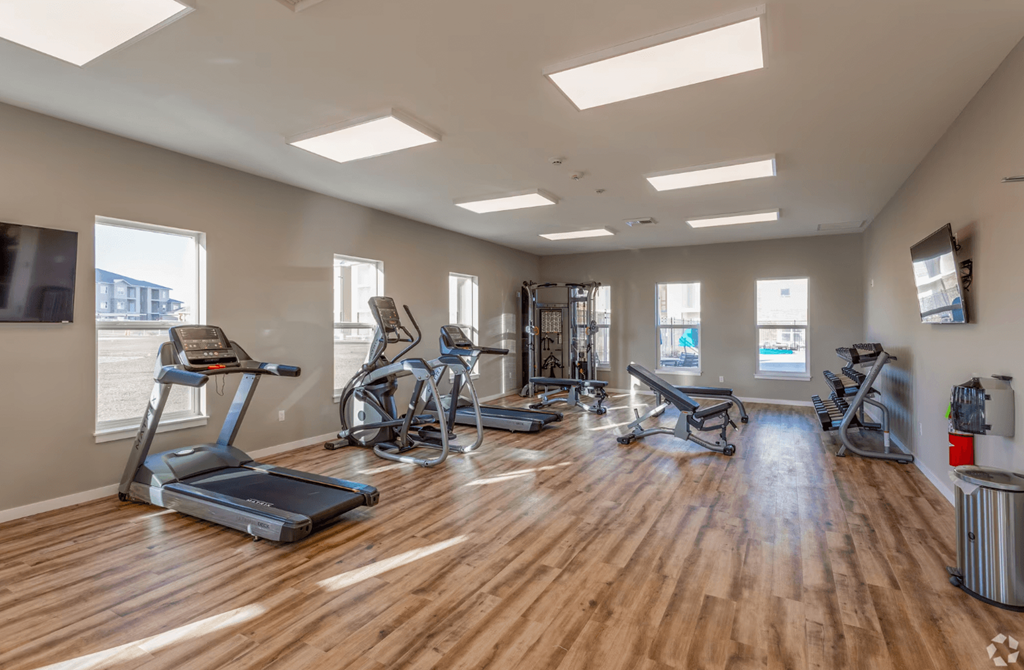 fitness center with treadmill and elliplticals