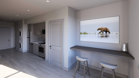 A modern kitchen with a bar stool and a painting of a bear in the background.
