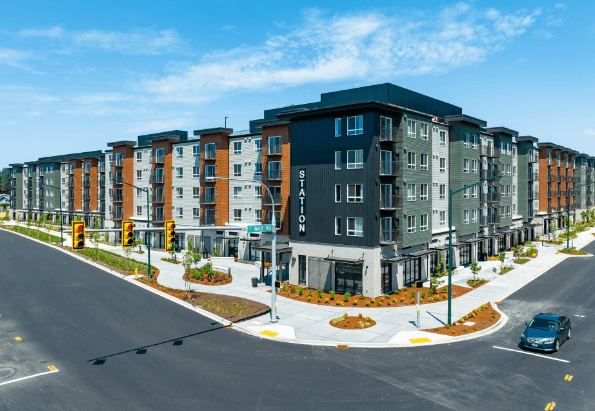 an aerial view of a large apartment complex with a car parked on the side of the road at STATION BY VINTAGE, COVINGTON