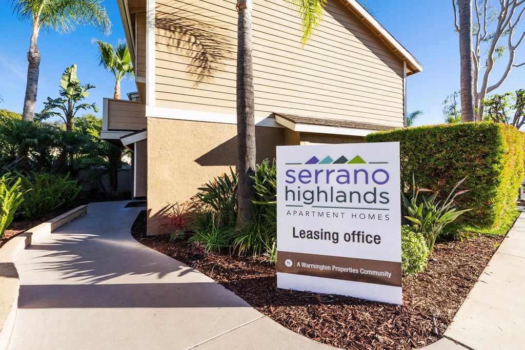 a leasing office sign in front of a building