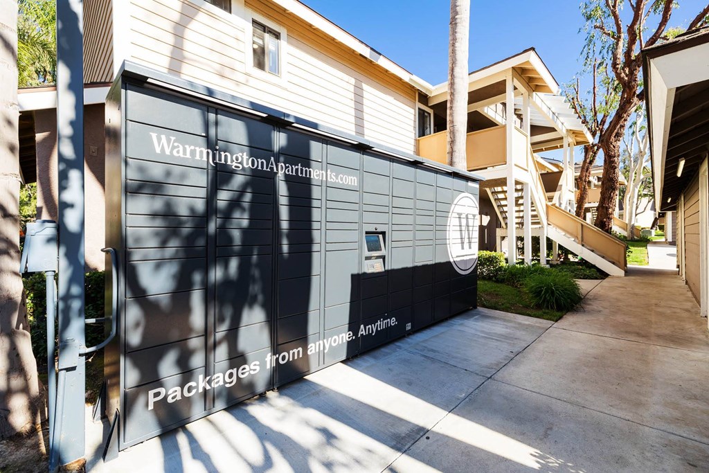 the side of a house with a driveway and a gate