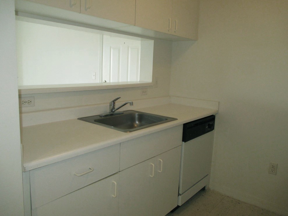 Siesta Pointe apartment home kitchen with white appliances and white cabinetry at Siesta Pointe, Florida