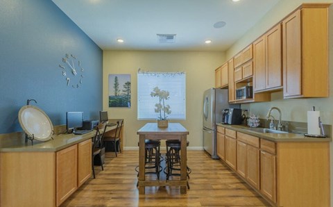 a kitchen with wooden cabinets and a dining room table