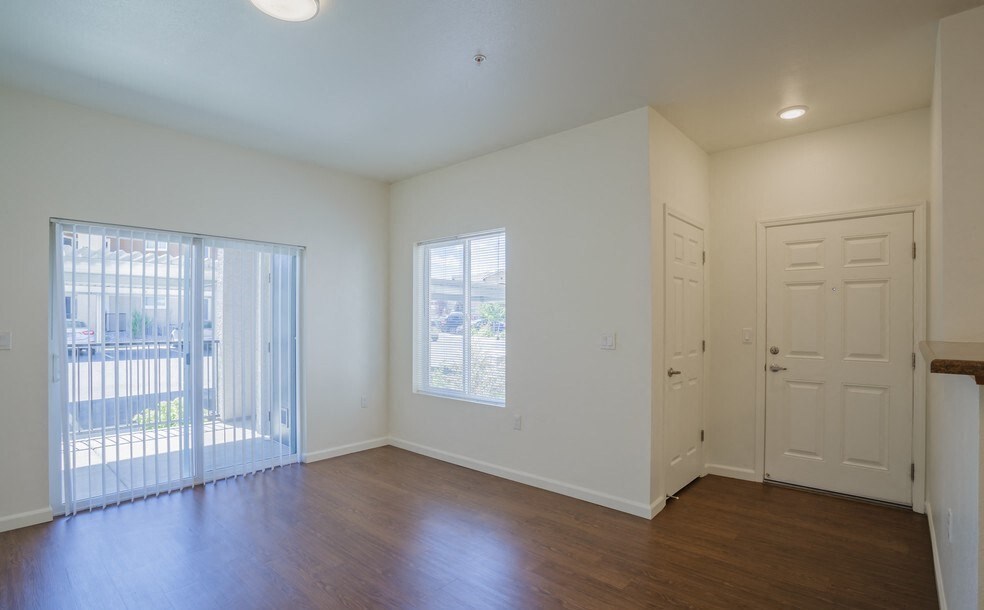 Apartments in Reno Nevada for Rent - Sky Vista Commons - Living Room with Open Floor Plan, Access to Balcony, and Glass Sliding Doors