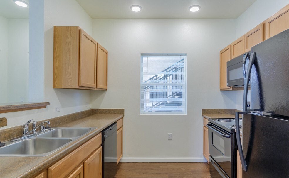 Reno Apartments - Sky Vista Commons - Kitchen with Black Kitchen Appliances, Cabinets, and Built-in Lighting